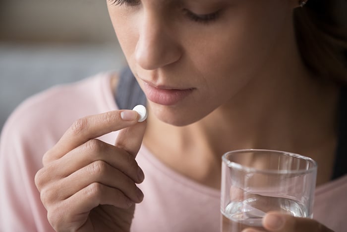 Woman taking abortion pill